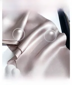 Detailed close-up of smooth champagne silk scarf fabric with elegant draped texture