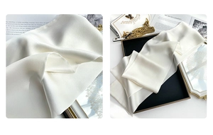 Close-up of white silk scarf showing premium satin texture and elegant pearly luster