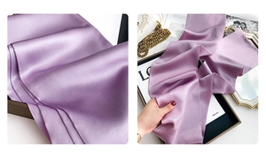 Detail of light purple silk scarf showing satin texture with luxury accessories