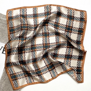 Detailed view of silk plaid square scarf featuring brown houndstooth and stripe patterns