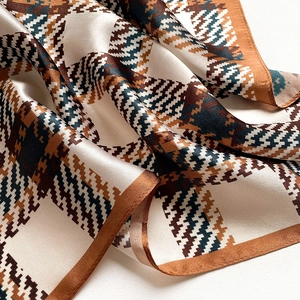 Macro shot of silk scarf with plaid geometric pattern and fine stitched edges