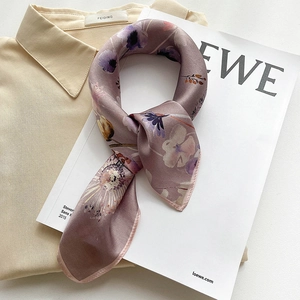 Elegant lavender silk square scarf with floral print styled on a white shirt and magazine