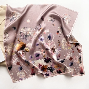 Detail of silk square scarf showing pink floral dandelion print on satin fabric