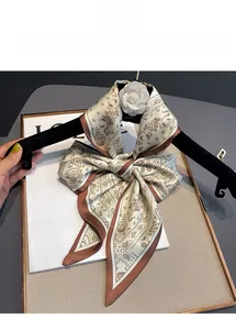 Detail of beige paisley silk scarf tied in a bow showing the smooth satin texture