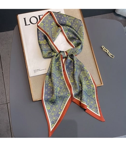 Detail of grey-blue paisley pattern silk scarf with contrast orange rolled edges