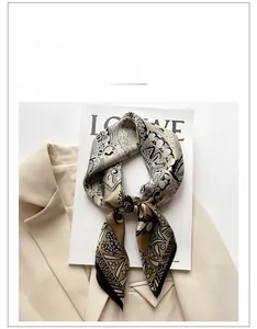 Detailed pattern view of printed silk scarf with floral and geometric earth tones
