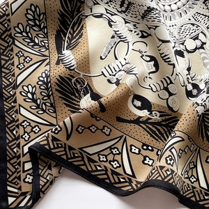 Detail view of bohemian floral pattern silk scarf with fine rolled edges and silky luster