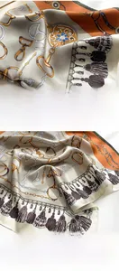 Detailed macro view of high-quality silk scarf with chain prints and machine-stitched edges