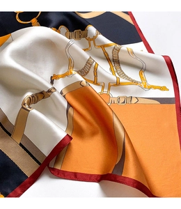 Detail of silk-feel satin scarf with orange equestrian equestrian horse bit patterns