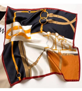 Detailed view of luxury silk scarf with equestrian horse harness and buckle patterns