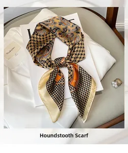Elegant houndstooth and paisley silk-like scarf draped over a suit with pearl ring detail