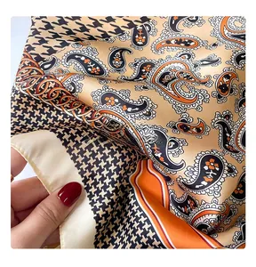 Detail of vintage paisley and houndstooth silk scarf with fine machine-stitched edges