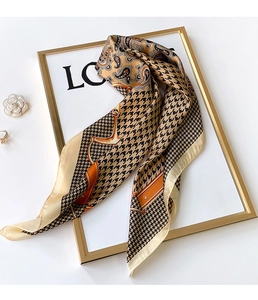 Detail of silk-satin scarf featuring houndstooth, paisley patterns and equestrian motifs