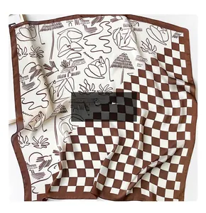 Detail of square silk scarf showing brown checkerboard pattern and abstract line art design