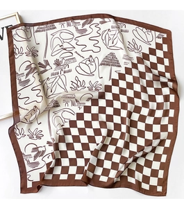 Detailed shot of checkerboard and artistic line drawing pattern on a silk scarf