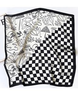 Detail of checkered and abstract print silk-like scarf with elegant draped texture