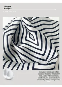 Detailed view of the smooth, natural mulberry silk fabric with black and white geometric patterns