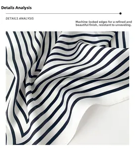 Detailed macro shot of black and white striped silk scarf with machine-hemmed edges