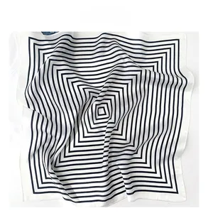 Detail of black and white striped silk scarf showing satin texture and fine stitching