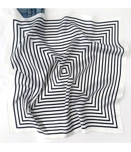 Detail of silk scarf with geometric black and white square stripes and satin texture