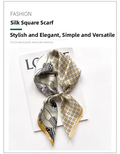 Detail of silk scarf showing vintage print with yellow hand-rolled edges on white background