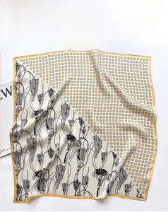 Close-up of silk square scarf showing vintage floral patterns and soft fabric texture