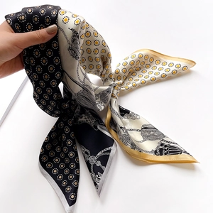 Close-up of vintage silk scarf showing intricate gold rope patterns and yellow dots texture