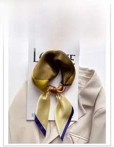 Detail of multi-colored silk square scarf on a beige blazer and white magazine