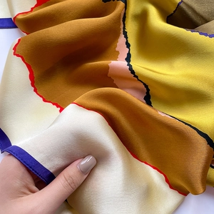 Detail showing high-quality silk scarf with color-blocking and hand-drawn lines