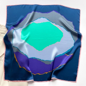 Detail of silk square scarf featuring abstract mineral textures and pink rolled edges