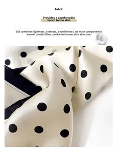 Detailed view of luxury polka dot silk scarf with smooth texture and soft sheen