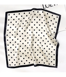 Detailed view of polka dot silk square scarf with premium texture and black border