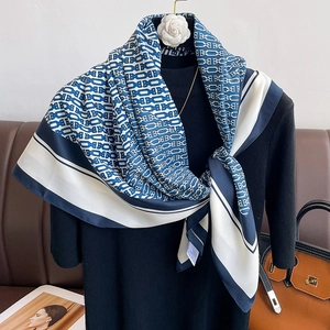 Elegant blue and white geometric chain print silk scarf on a stylish mannequin