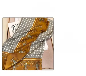 Macro shot of twill silk scarf showing violin pattern and glossy fabric texture