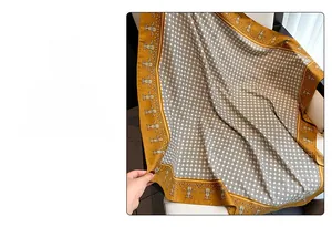 Detail of elegant orange and beige twill silk scarf showing vintage pattern and soft texture