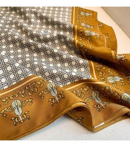 Detail of elegant satin scarf with vintage violin patterns and baroque floral gold border