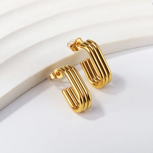 Golden stainless steel U-shaped earrings with geometric parallel lines in a modern design
