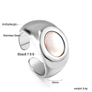 Detailed view of stainless steel wide ring with oval white shell inlay and size chart