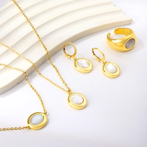Elegant gold-tone stainless steel jewelry set with white shell oval stone accents