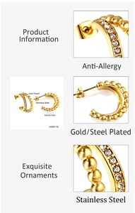 Detail of gold C-shaped earrings with steel beads and sparkling rhinestone pavé setting