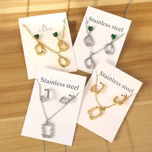 Stainless steel jewelry set featuring heart green stones and asymmetric lava textures