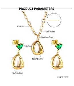 Detail of gold-plated stainless steel necklace with green heart gem and teardrop pendant