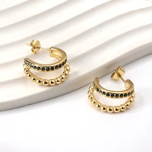 Double-layered gold C-shape hoop earrings with green zircon stones and beaded edges
