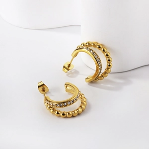 Golden double-layer hoop earrings featuring sparkling crystals and beaded metal textures