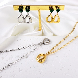 Stainless steel jewelry set featuring heart green stones and fluid irregular round charms
