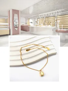 Detailed close-up of 18K gold-plated heart lock pendant with fine cable chain and clasp