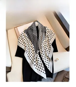 Close-up of retro geometric print square scarf with black and white satin texture