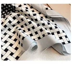 Detail of meticulous lockstitch edging on geometric print silk scarf with smooth texture