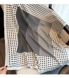 Detail of black and white geometric pattern satin square scarf with smooth silk texture