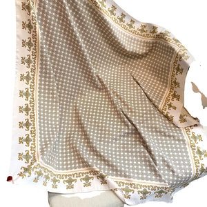 Elegant silk scarf with beige geometric chain pattern and golden baroque floral borders